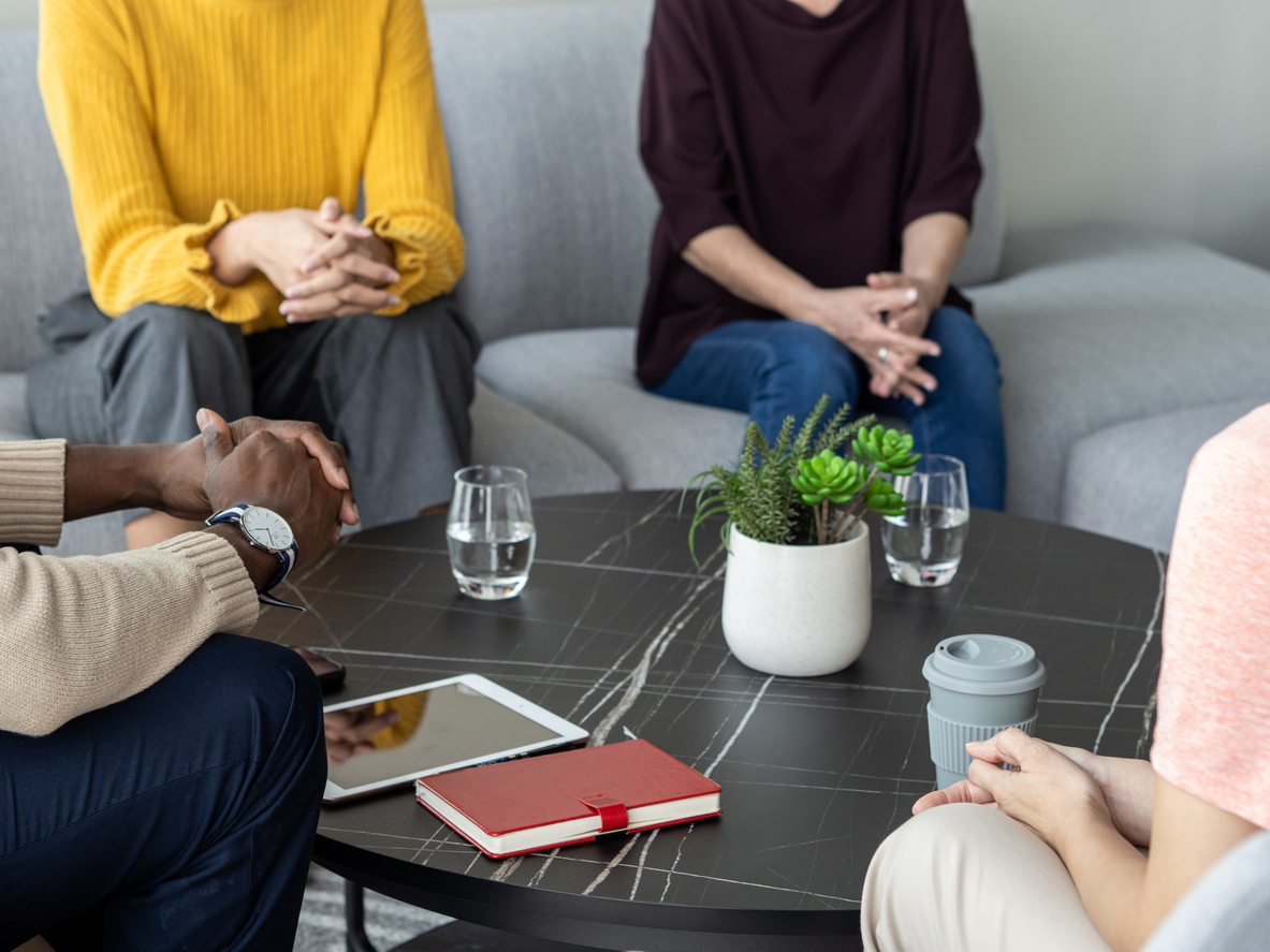 Mental Wellness - Diverse participants at mental health workshop seated in a small circle (possibly sharing personal stories)